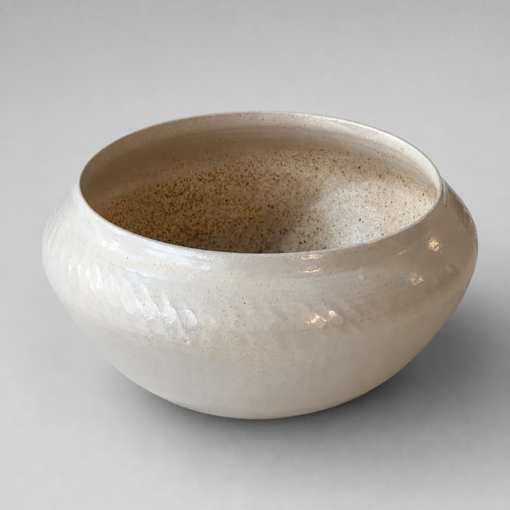 Medium, cream stoneware serving bowl in speckled cream