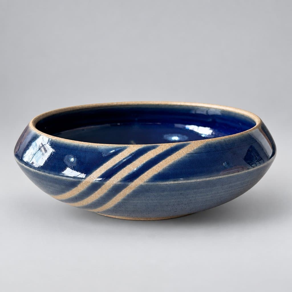 Small, toffee stoneware snack bowl in dark blue