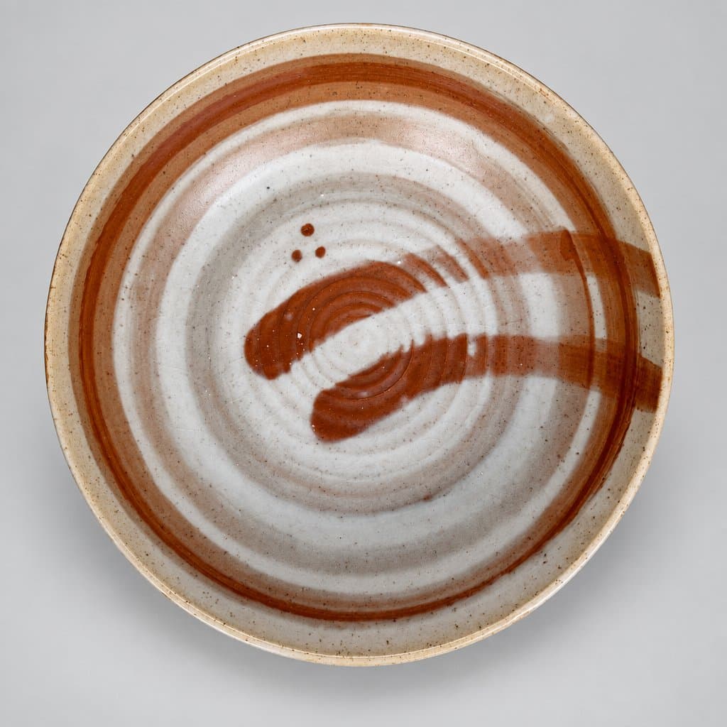 Large, low, speckled cream stoneware serving bowl in milky matte and burnt umber.