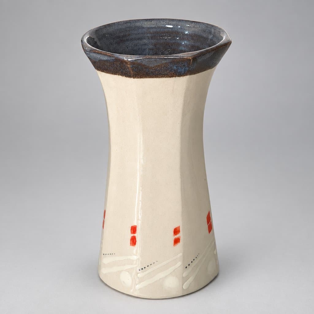 Faceted, slip-decorated, cream stoneware vase in glossy translucent and fog