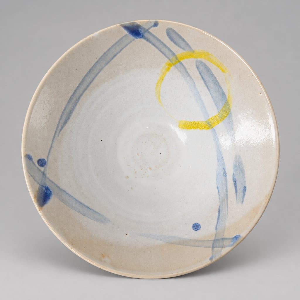 V shaped creme stoneware bowl in glossy white, sky blue, and lemon